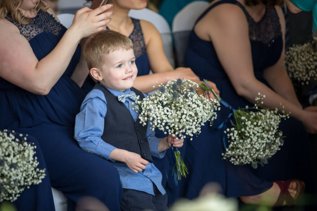 pageboy holds bridesmaid bouquet holiday inn milton keynes oxfordshire wedding photographers