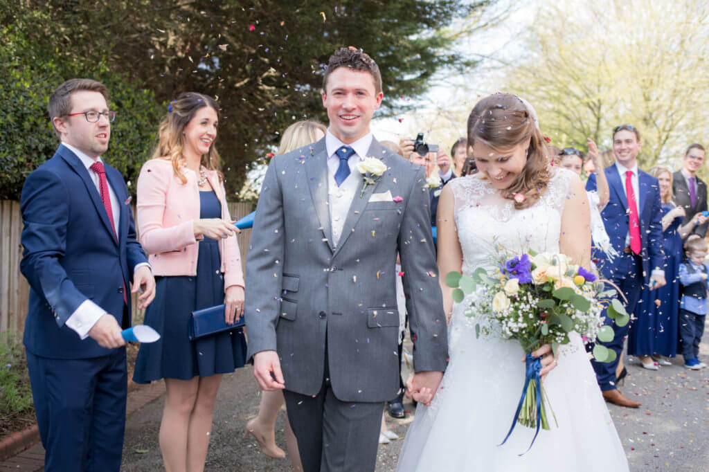 smiling bride groom confetti parade holiday inn milton keynes oxfordshire wedding photographer
