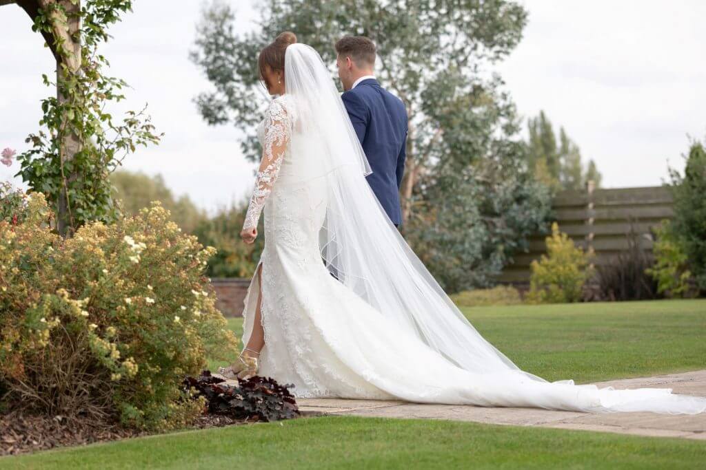 18 bride groom stroll through formal gardens of mythe barn luxury venue leicestershire oxford wedding photography