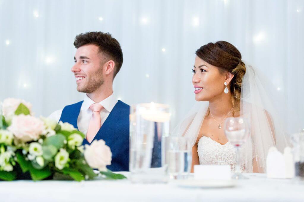 bride groom with table decorations listen to speeches reception dinner milton hill house venue steventon abingdon oxford oxfordshire wedding photography 25