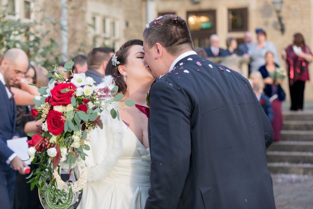 bride groom kiss after confetti south lodge hotel west sussex oxford wedding photographer