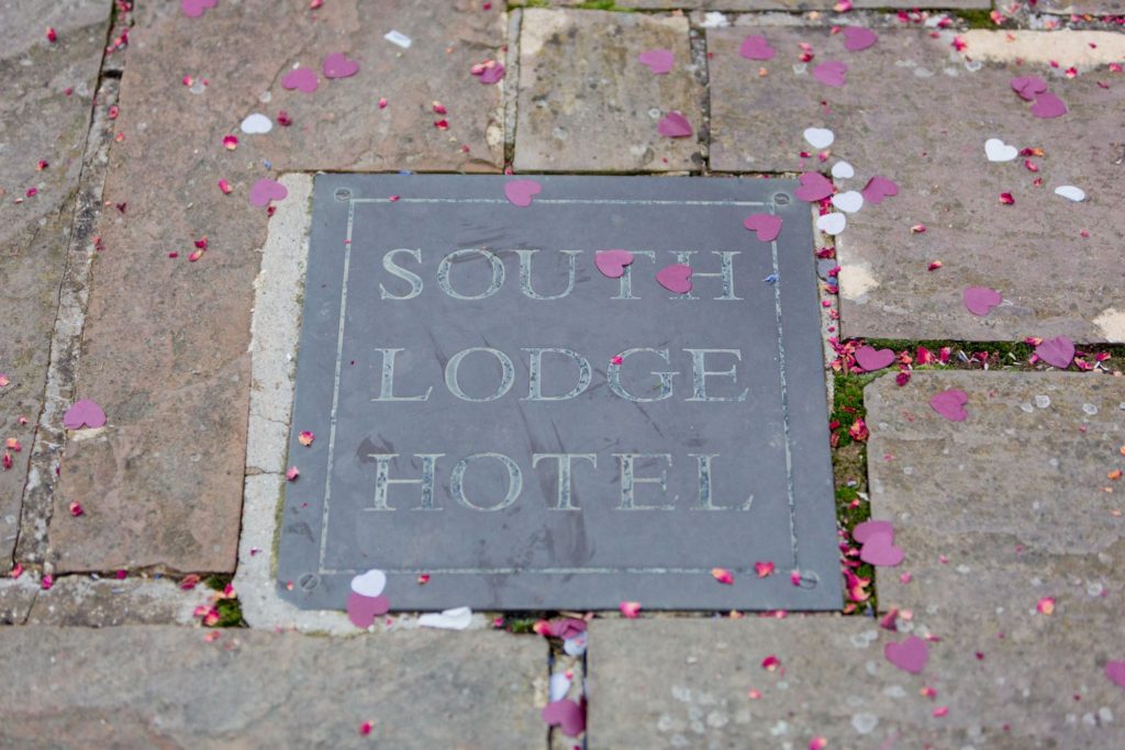 confetti on hotel sign exclusive south lodge venue west sussex oxford wedding photography
