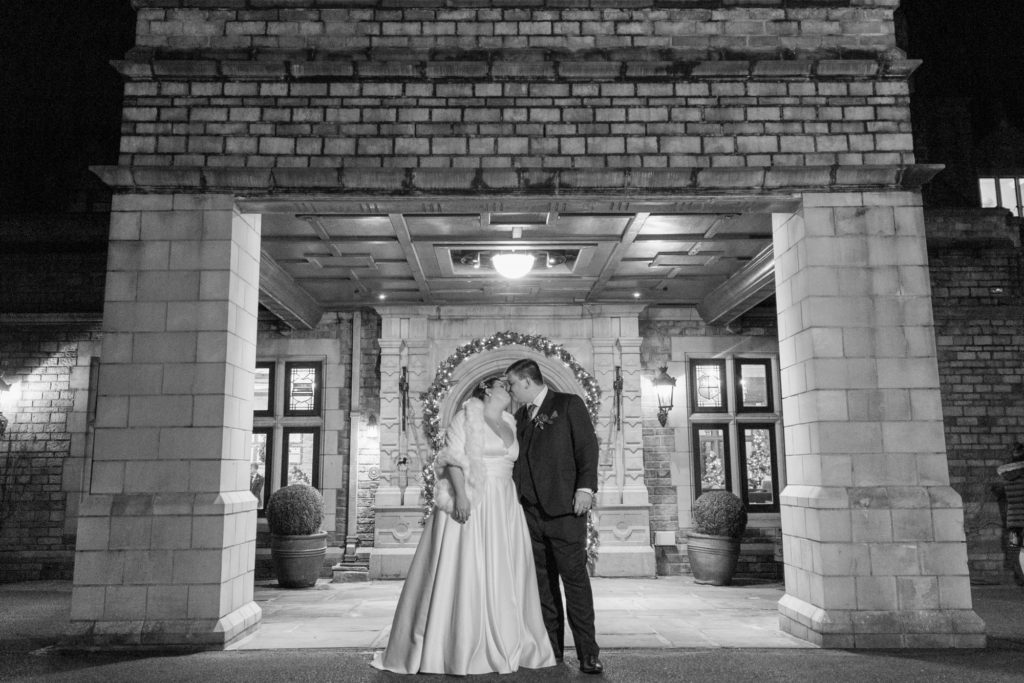 bride groom kiss at venue entrance south lodge hotel west sussex oxfordshire wedding photographer