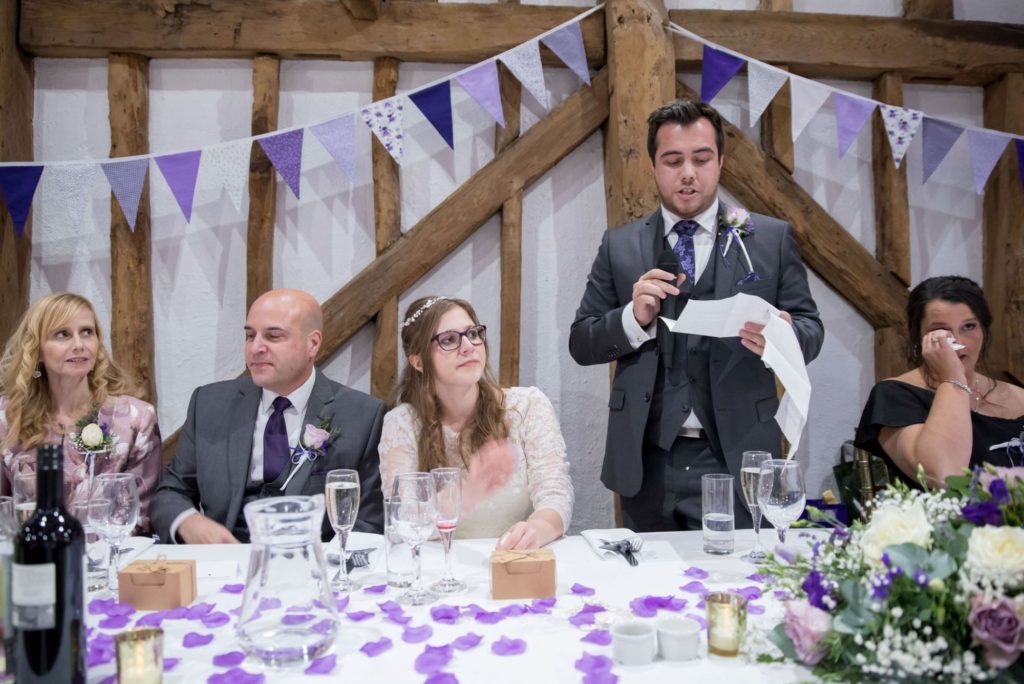 Tearful mother listens to groom's speech barn venue reception dinner oxford wedding photography