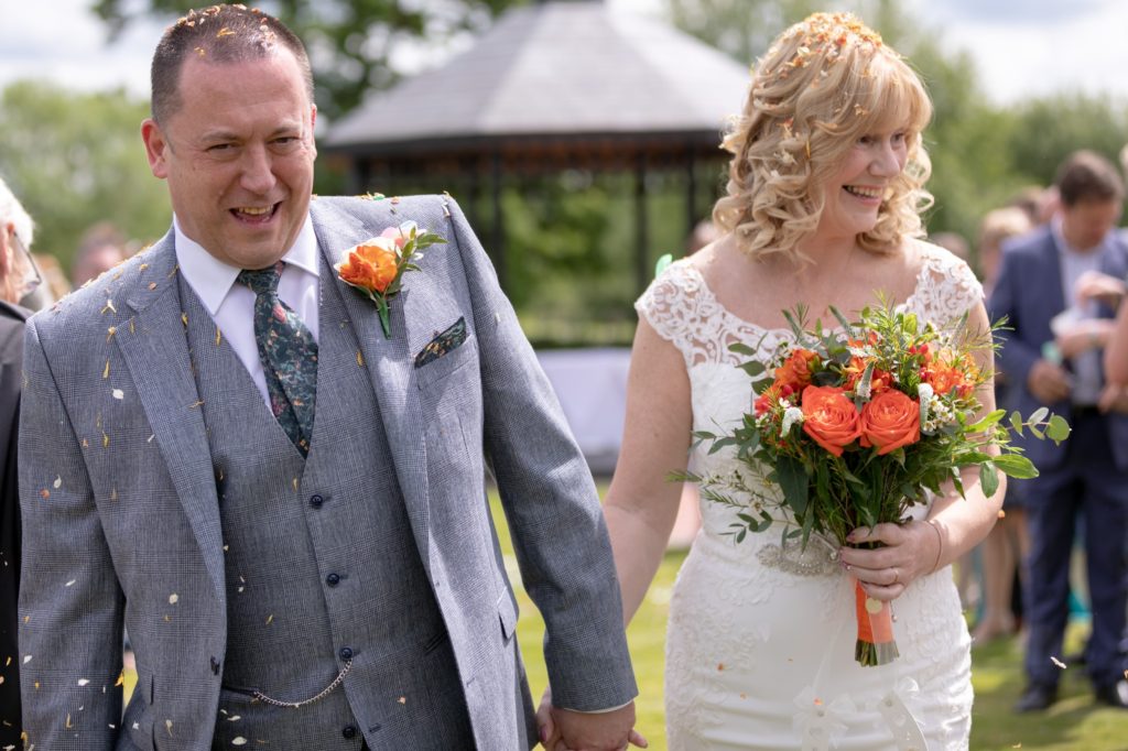 37 happy bride groom showered in confetti ardencote hotel venue warwick oxford wedding photographers