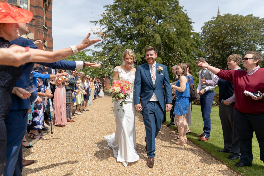 19 guests throw confetti over bride groom the elvetham hartley wintney hampshire oxfordshire wedding photography