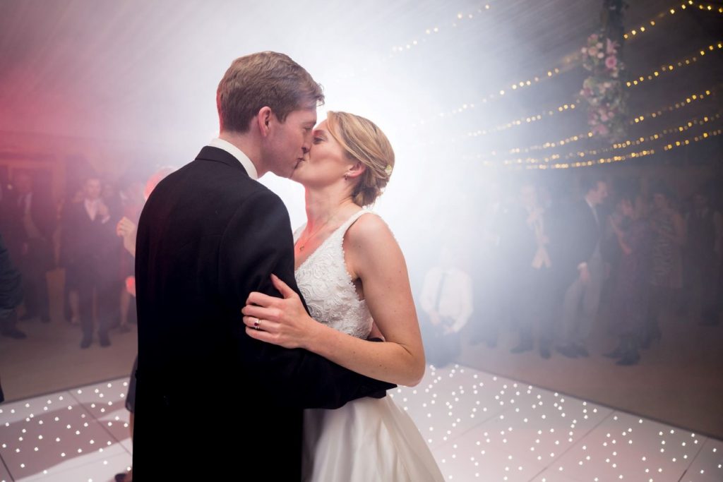 bride groom kiss under fairy lights marquee reception blenheim palace woodstock oxfordshire oxford wedding photographers
