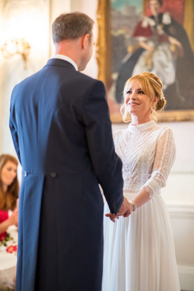 17 bride smiles towards groom marriage ceremony lansdowne club mayfair london oxfordshire wedding photographers