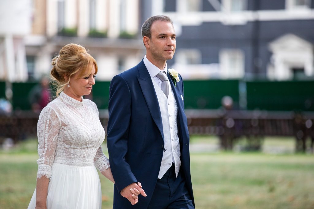 bride groom stroll hand in hand lansdowne club marriage mayfair london oxfordshire wedding photography