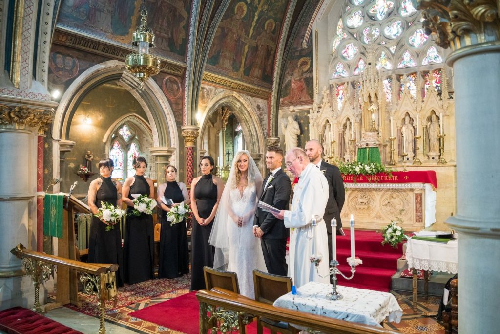 priest conducts marriage ceremony st marys catholic church husbands bosworth leicestershire oxfordshire wedding photographers