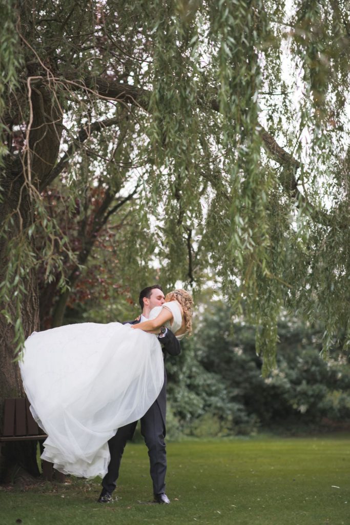 groom lifts bride wroxeter hotel gardens shrewsbury shropshire oxford wedding photographers