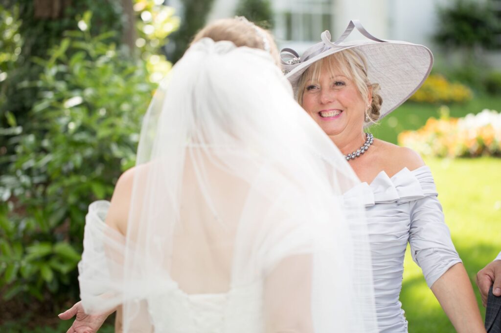 mother of bride greets bride champagne reception de vere beaumont hotel windsor oxfordshire wedding photography