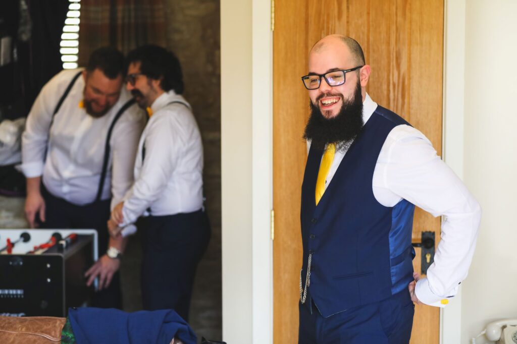 laughing groom grooms preparation caswell house venue oxford wedding photographer