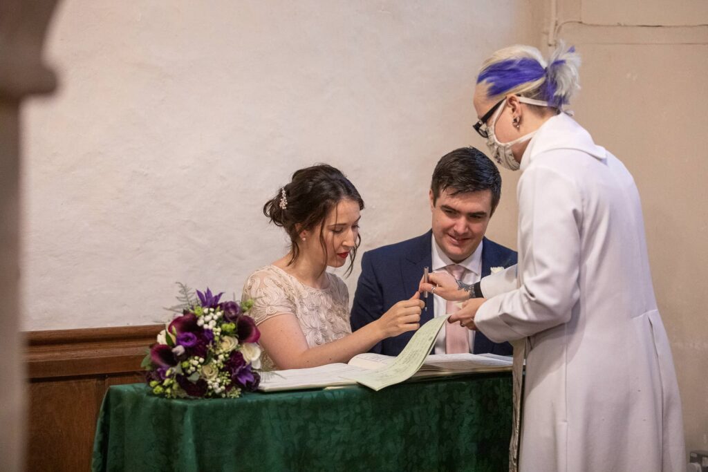 bride groom baby marriage register signing ceremony st nicholas church oxford wedding photography