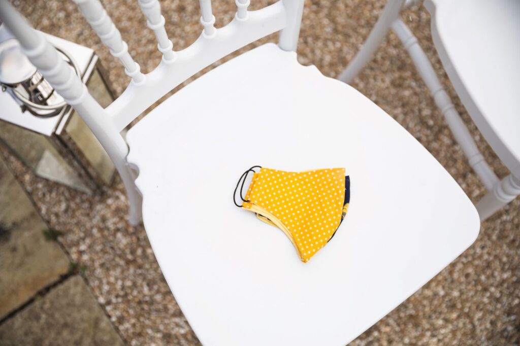 yellow covid mask white outdoor ceremony chair caswell house venue oxford wedding photographer