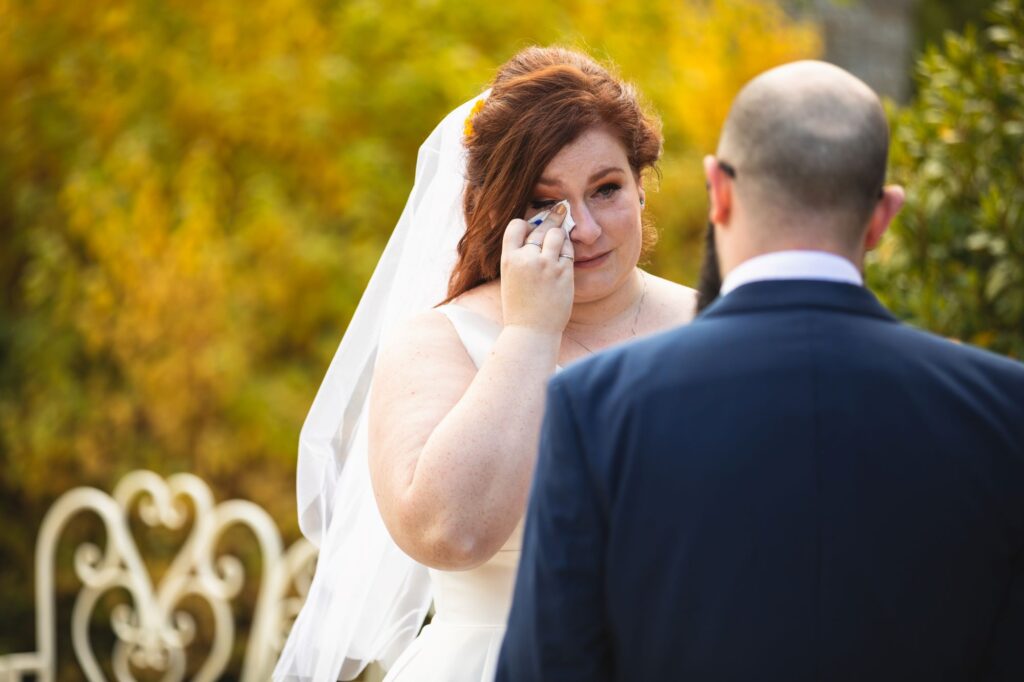 bride wipes tear outdoor marriage ceremony caswell house oxfordshire wedding photographers