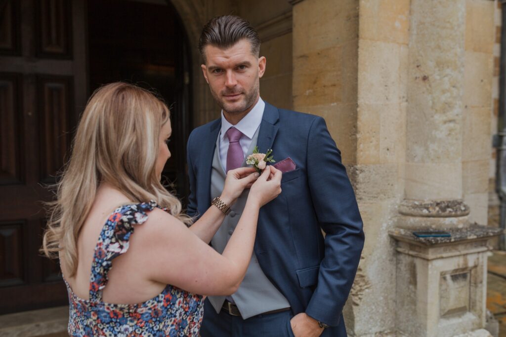 grooms corsage attached groom preparation holdenby northamptonshire oxford wedding photography