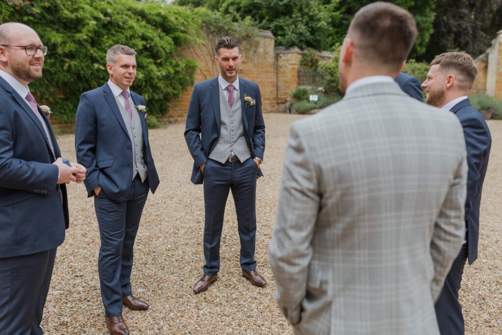 groomsmen gather holdenby house courtyard northamptonshire oxford wedding photographers