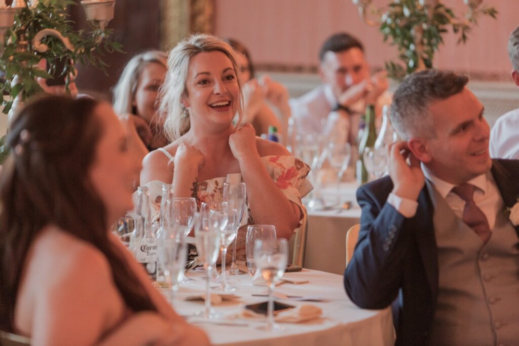 laughing guests enjoy wedding breakfast speech holdenby northamptonshire oxford wedding photographers