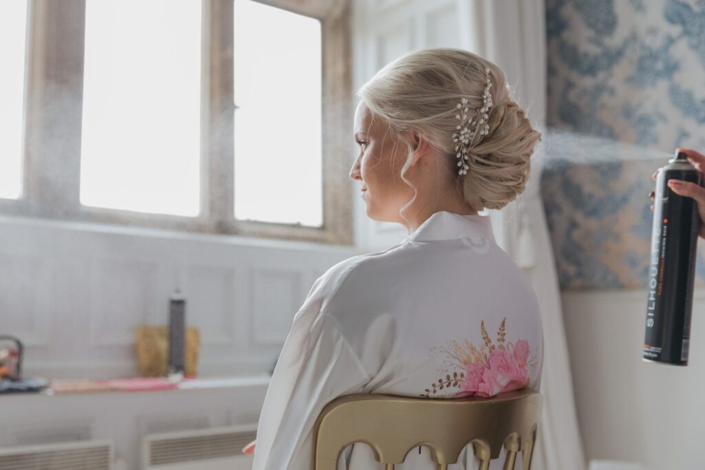 stylist sprays brides hair bridal preparation holdenby house northampton oxford wedding photography