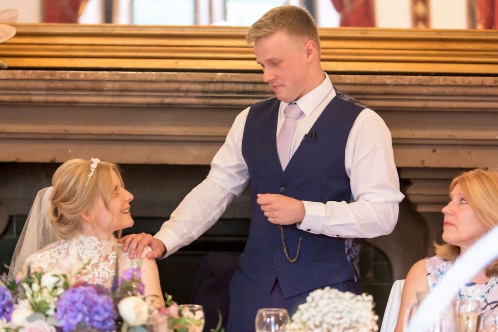 104 groom places hand on brides shoulder top table speech tarporley cheshire oxford wedding photographers