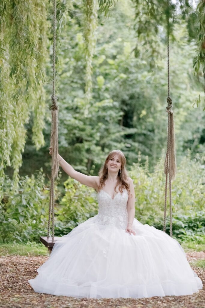 119 bride on garden swing callow end worcester oxfordshire wedding photography