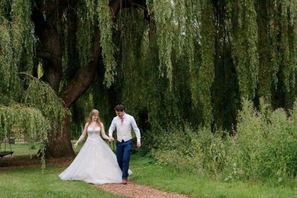 120 bride groom stroll beneath willow trees callow end gardens worcester oxford wedding photographer