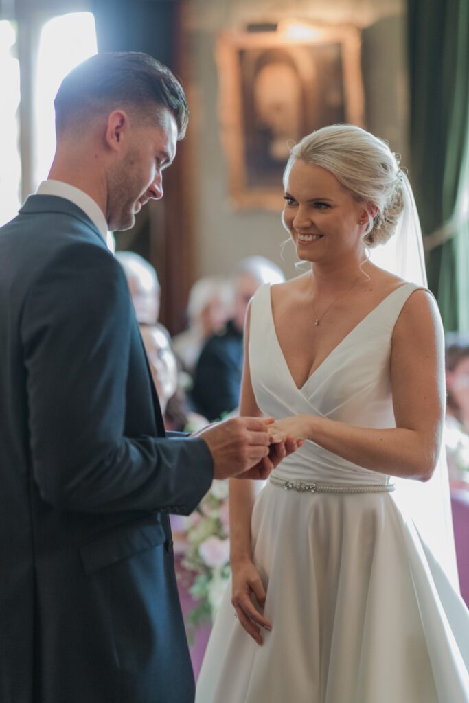 groom places brides ring marriage ceremony holdenby house northampton oxfordshire wedding photographer