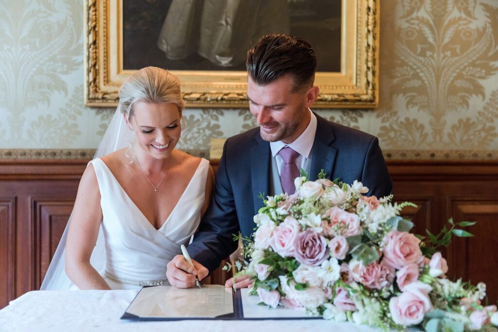 bride groom sign marriage register holdenby house northampton oxfordshire wedding photography