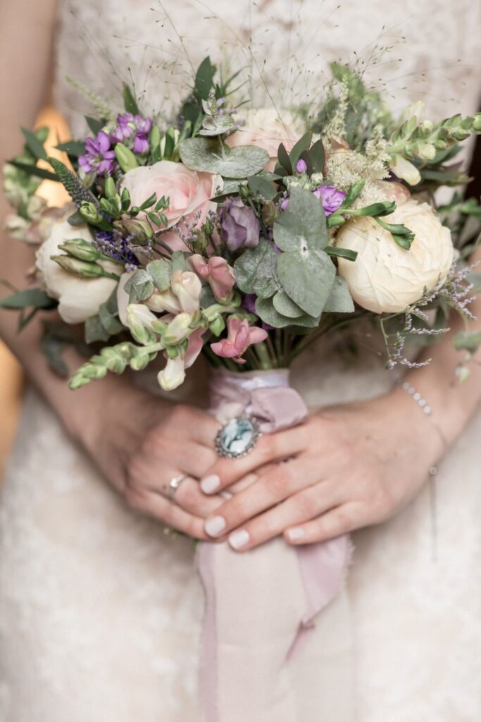 18 bride holds floral bouquet bridal prep peckforton castle cheshire oxford wedding photography