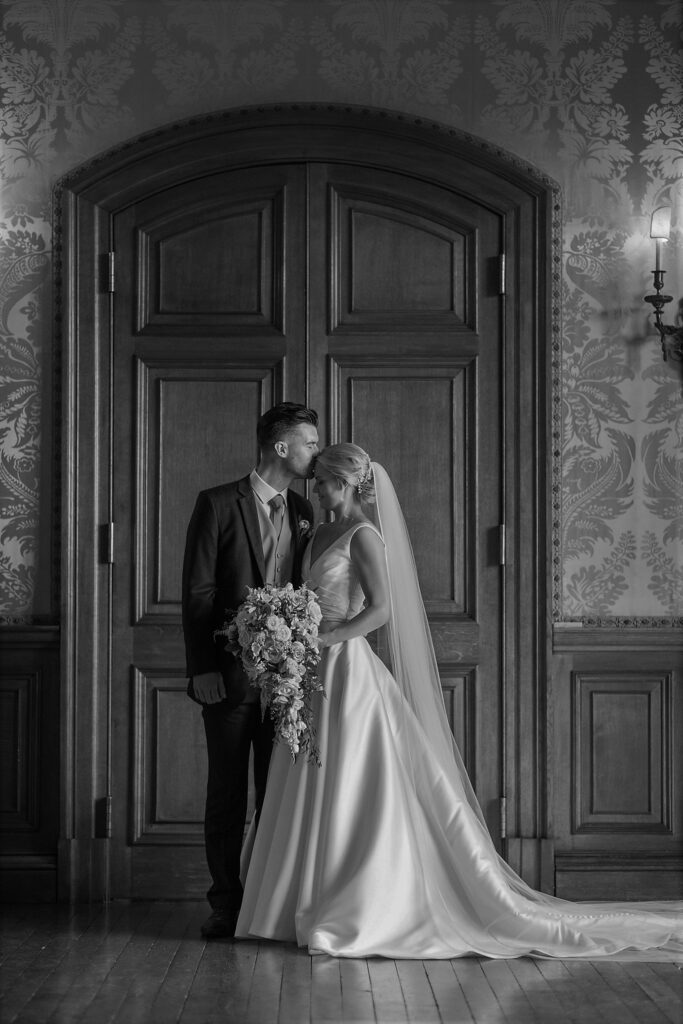 groom kises brides forehead holdenby house northampton oxford wedding photographers