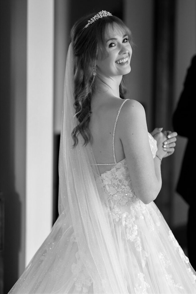 34 smiling bride departs bridal prep room callow end worcester oxfordshire wedding photography