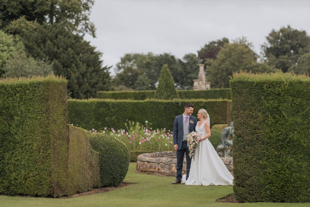 bride groom exchange glances holdenby house grounds northampton oxfordshire wedding photographers