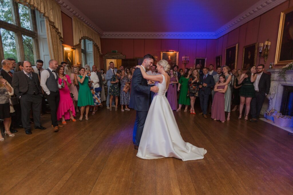 guests gather round bride grooms first dance holdenby house northampton oxfordshire wedding photographer