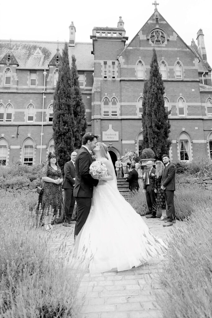 69 guests watch bride groom kiss stanbrook abbey hotel grounds worcestershire oxfordshire wedding photographers
