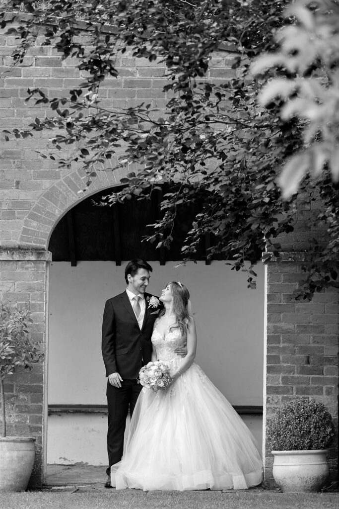 80 bride groom romantic moment under arch callow end worcester oxford wedding photography