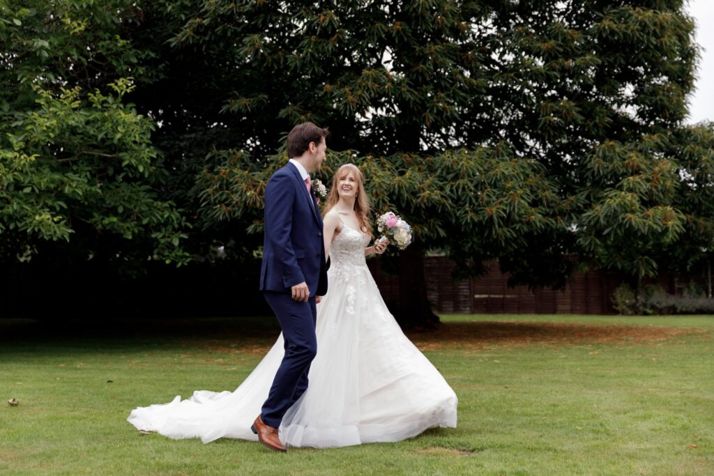81 bride groom stroll holding hands callow end gardens worcester oxfordshire wedding photographer