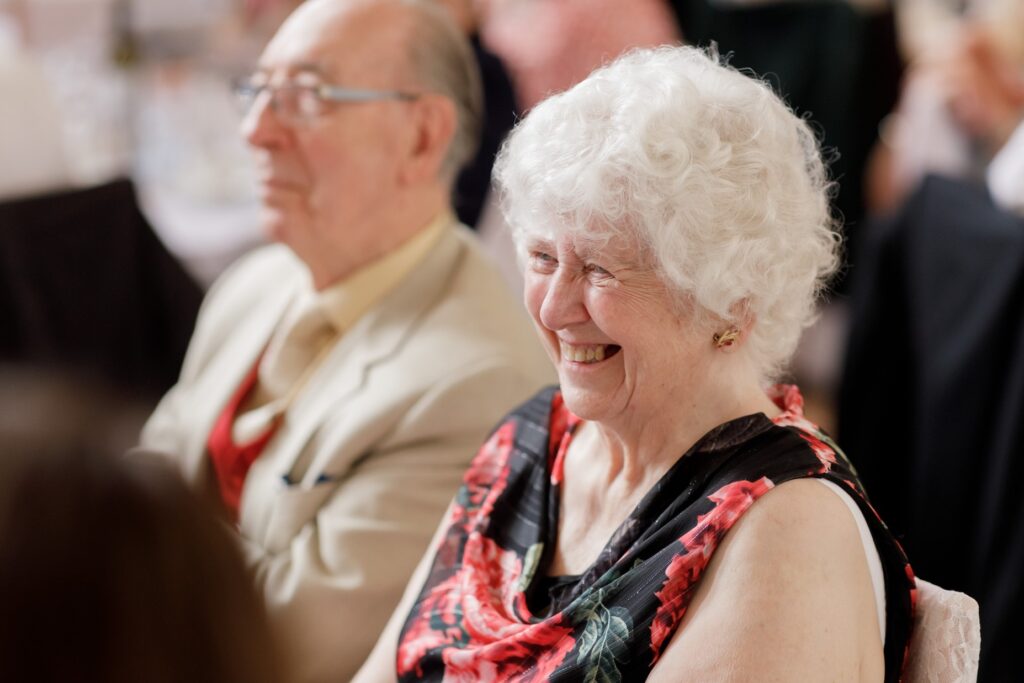 94 smiling guest enjoys grooms speech callow end worcester oxfordshire wedding photographers