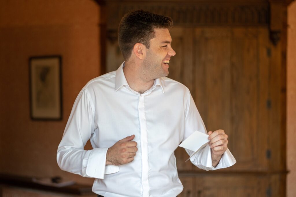 12 laughing groom reads brides note smallfield place venue surrey oxfordshire wedding photography