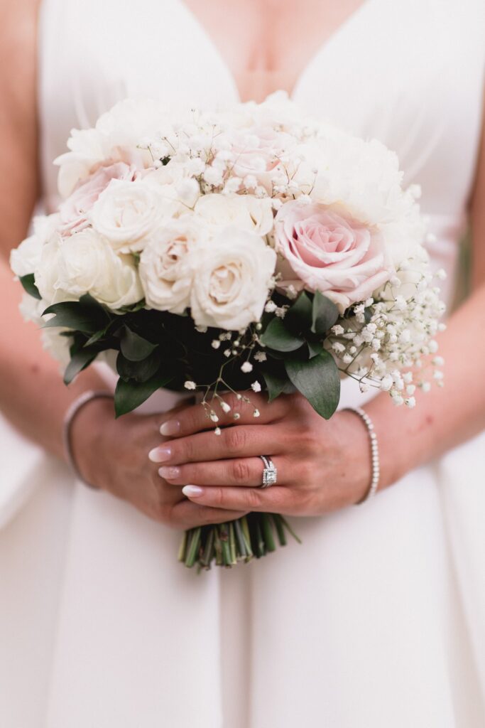 122 bride holds roses bouquet de vere hotel grounds wotton under edge oxfordshire wedding photographer