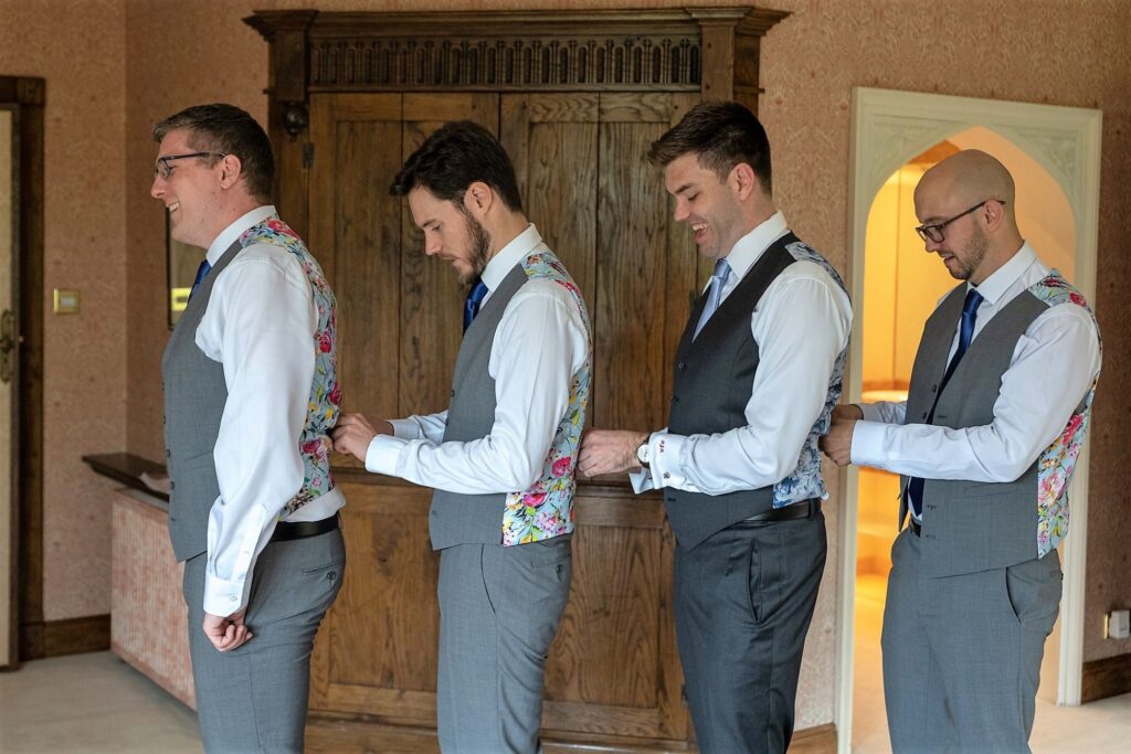 25 grooms party adjust waistcoats groom prep smallfield place surrey oxfordshire wedding photographers