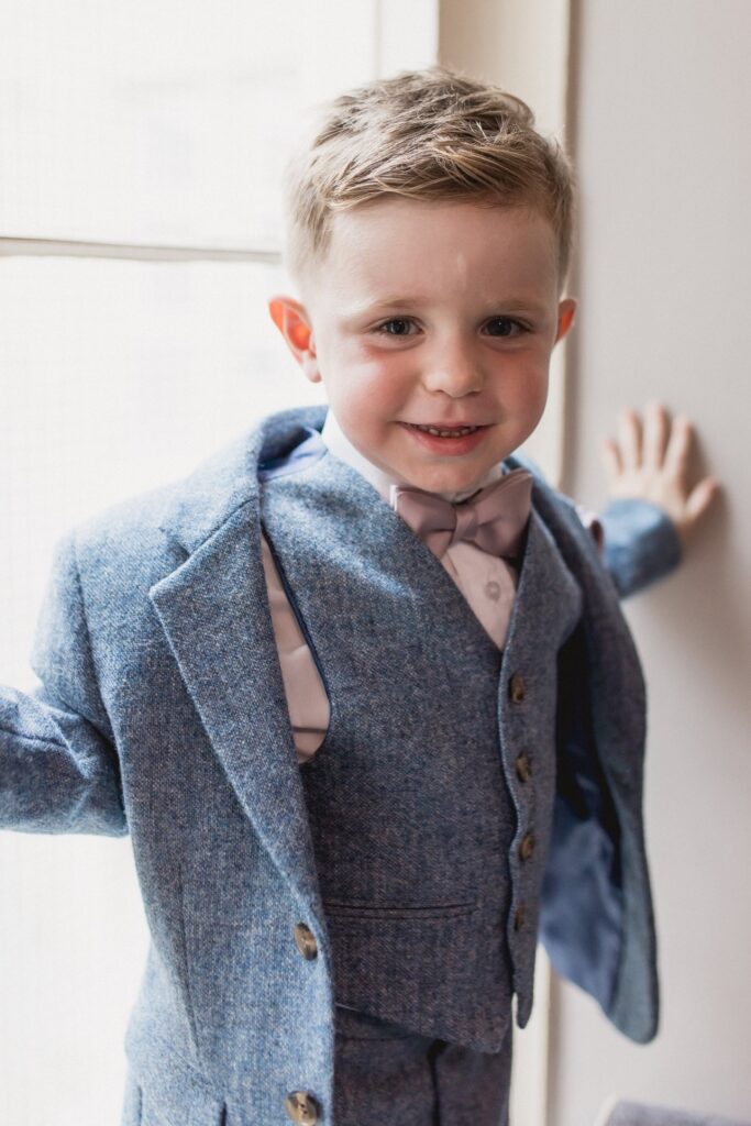 29 smiling pageboy completes groom prep tortworth court gloucestershire oxford wedding photography