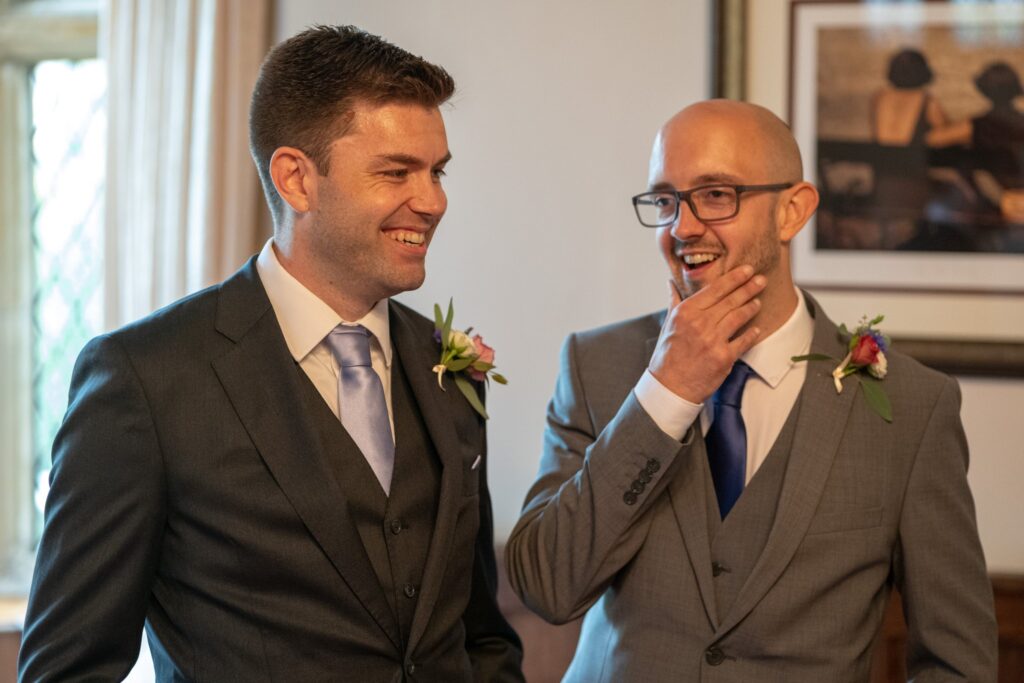 38 laughing guests await bride smallfield place ceremony surrey oxfordshire wedding photography