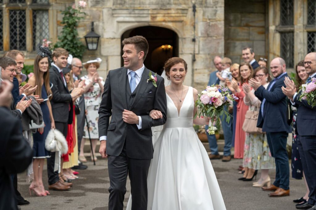56 bride groom walk between applauding guests cogmans lane surrey oxford wedding photographer