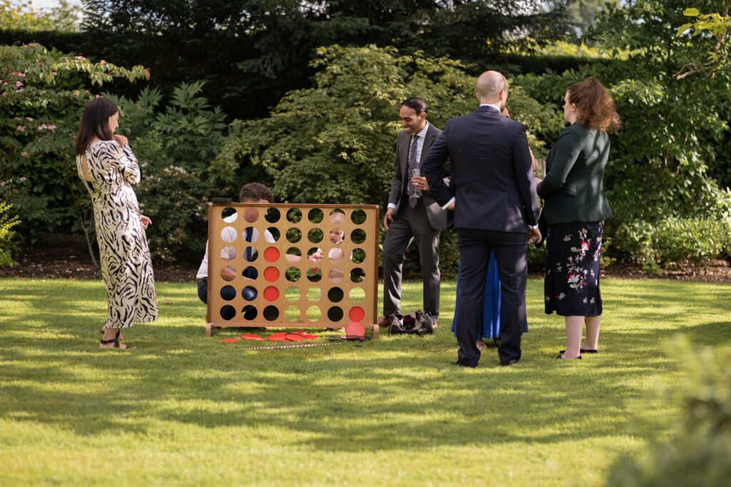 73 guests play giant garden game cogmans lane grounds surrey oxfordshire wedding photography