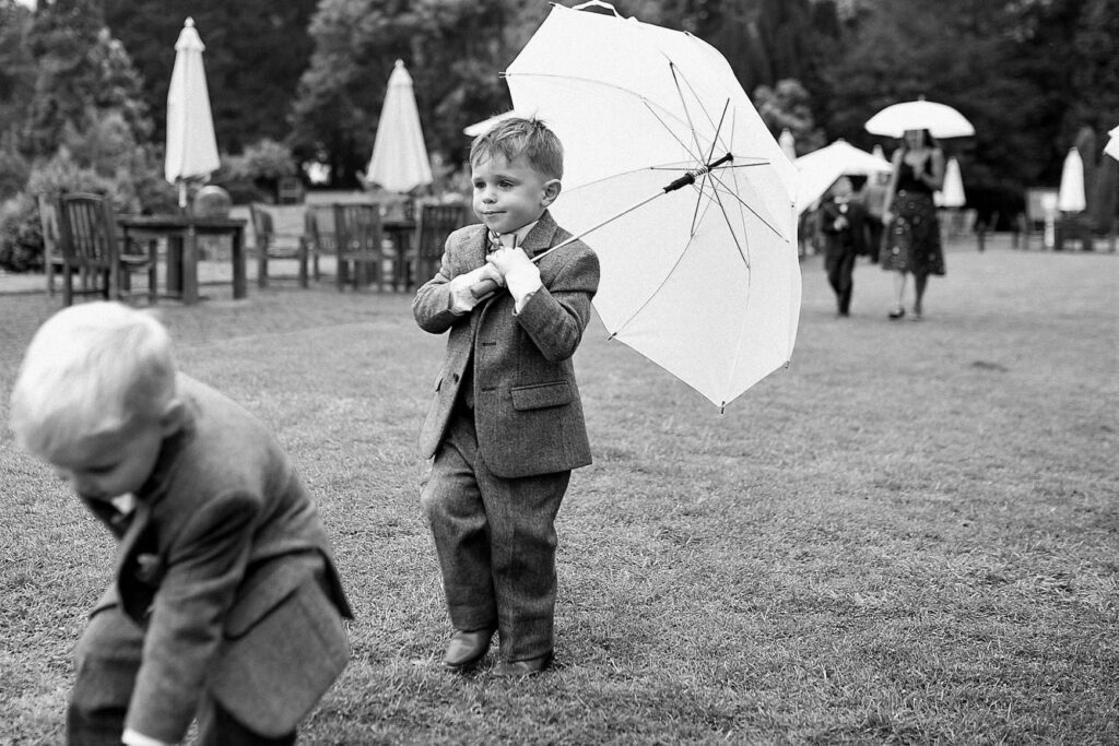 76 pageboy carries white umbrella de vere hotel champagne reception wotton under edge oxford wedding photographers