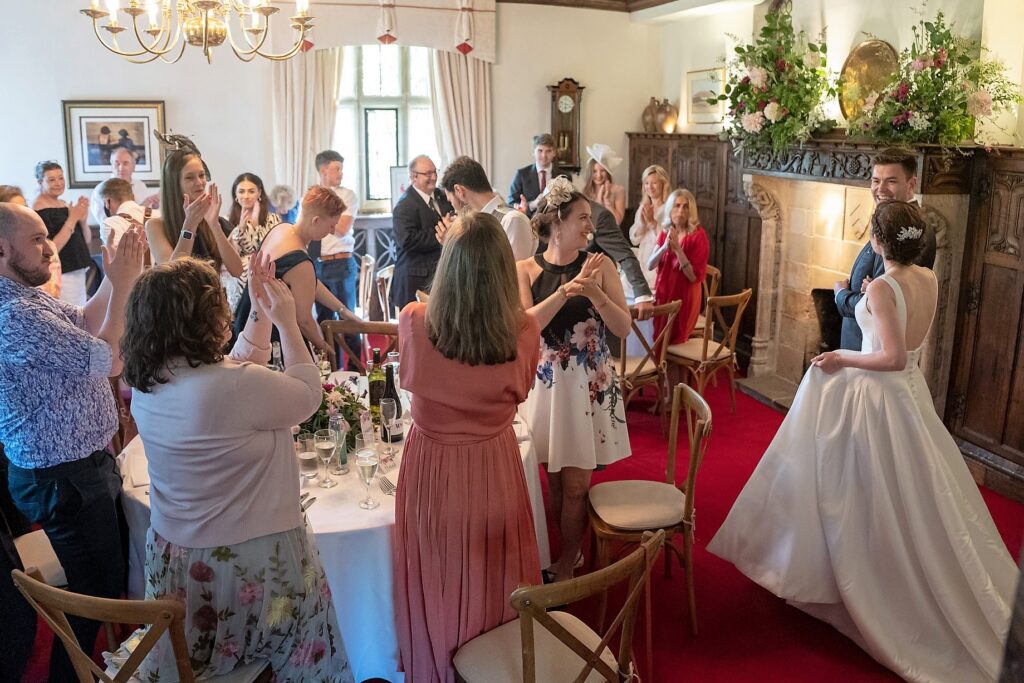 85 guests applaud bride grooms wedding breakfast entrance cogmans lane venue surrey oxford wedding photographers