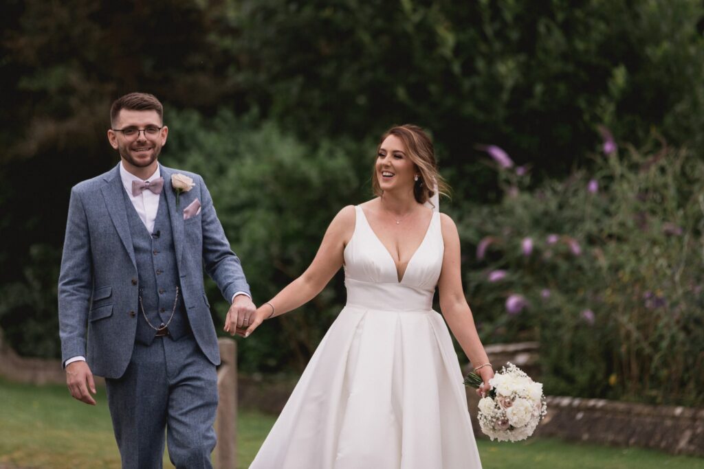 90 smiling bride groom hold hands de vere hotel grounds wotton under edge oxfordshire wedding photographer