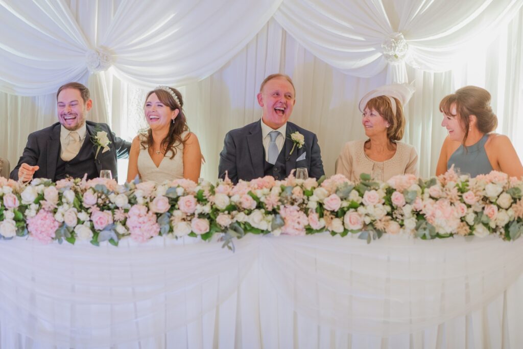 118 laughing top table bridal party hear bestmans speeh kimpton fitzroy london hotel oxfordshire wedding photographer