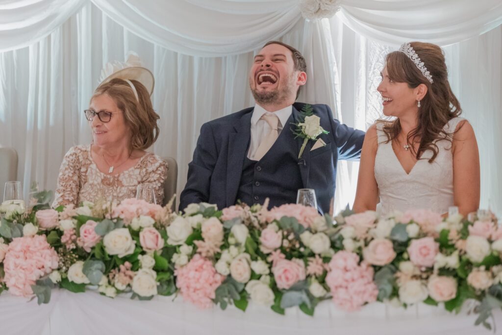 119 laughing groom hears bestmans speech kimpton fitzroy london hotel oxfordshire wedding photographers